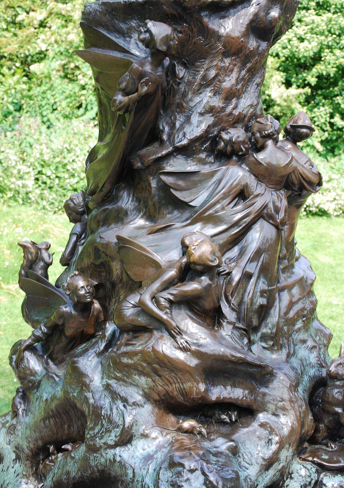 Detail: fairies climbing the bronze tree stump